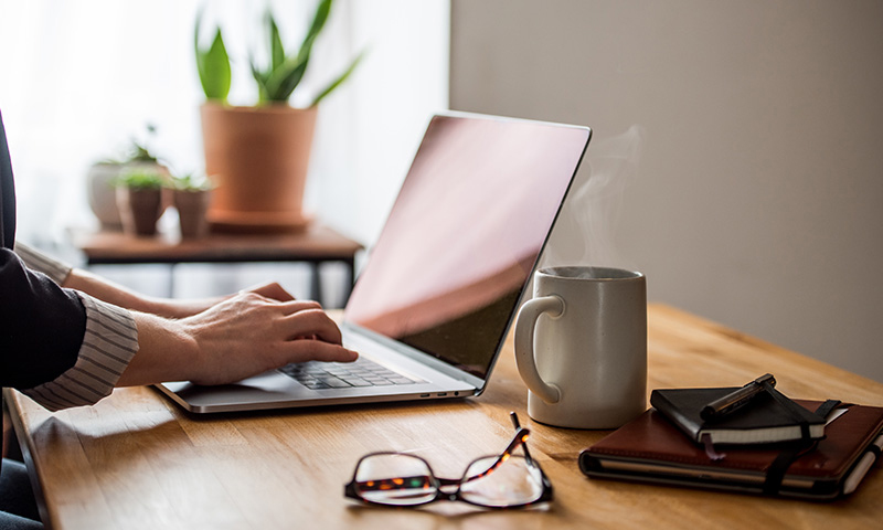 a female typing on a laptop